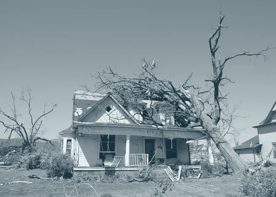 A home with its roof and upper walls torn away by a tornado